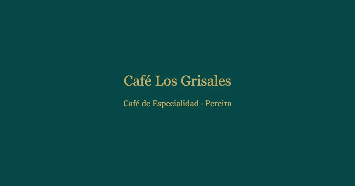 Cup of specialty coffee served at Café Los Grisales, Pereira, with fresh coffee beans in the background